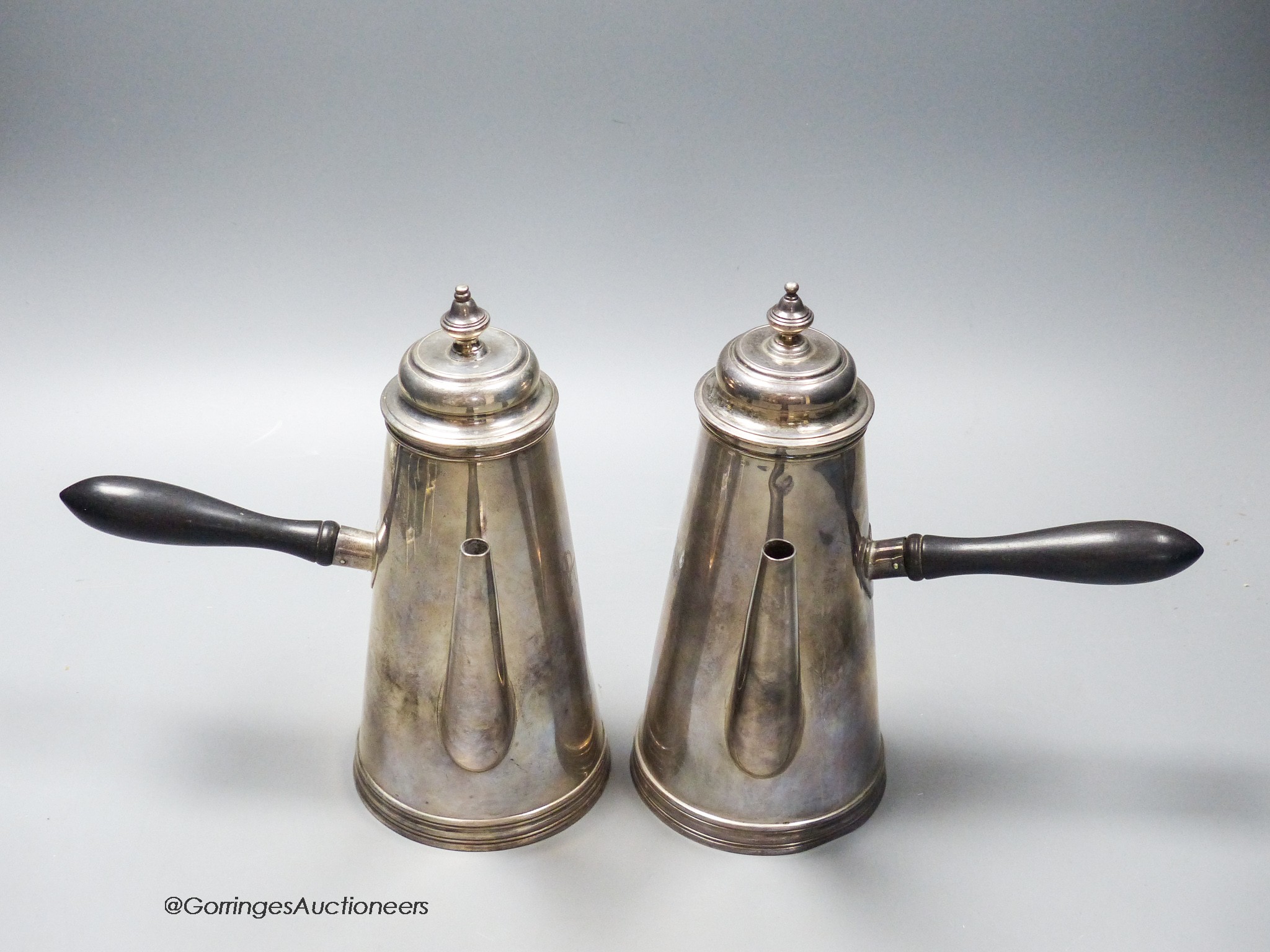 A late Victorian silver cafe au lait pair, Henry Stratford, Sheffield, 1899/1900, with engraved crest, gross 28.5oz.